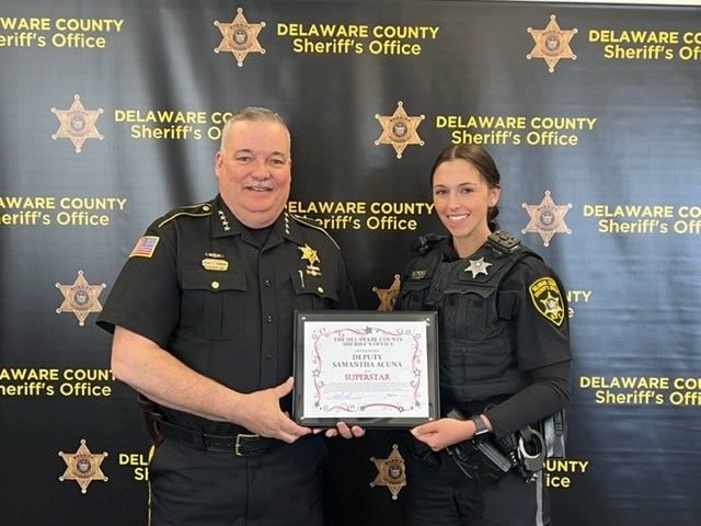 Sheriff Craig S. DuMond presents Deputy Samantha Acuna with award.